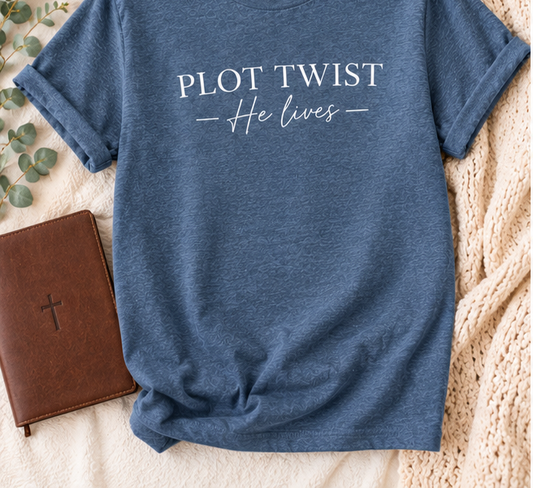 Plot Twist He Lives indigo blue T-shirt with cream knit lifestyle background